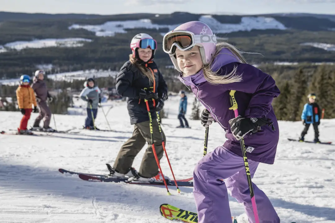 A family stands gathered on the slope