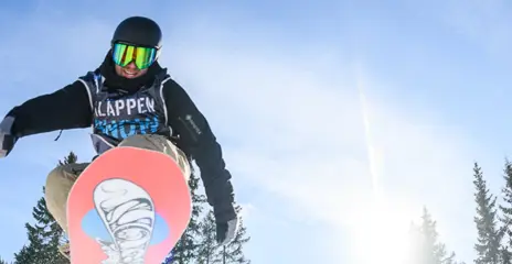 Swedish Championships in Kläppen Snowpark where a snowboarder performs tricks in the air