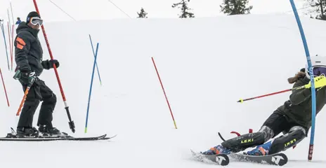 A coach cheers for a competitor in giant slalom