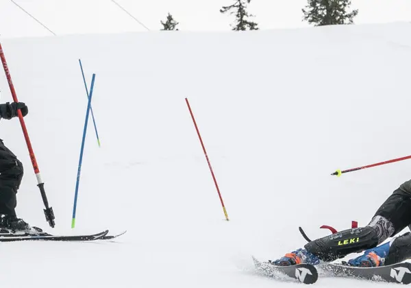 A coach cheers for a competitor in giant slalom